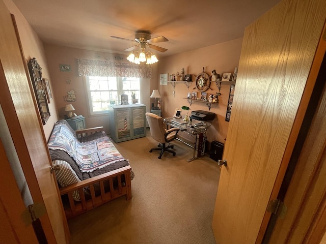 carpeted home office featuring ceiling fan