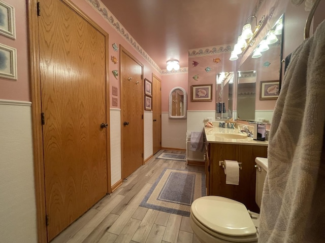 bathroom featuring hardwood / wood-style flooring, vanity, and toilet