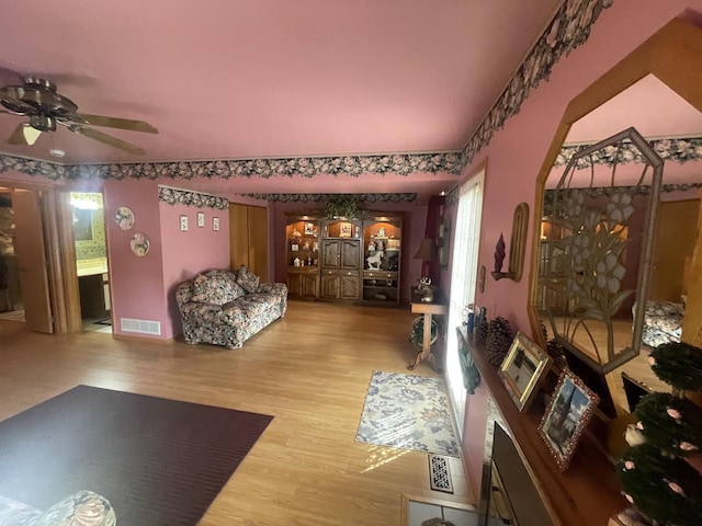 interior space with ceiling fan and hardwood / wood-style floors