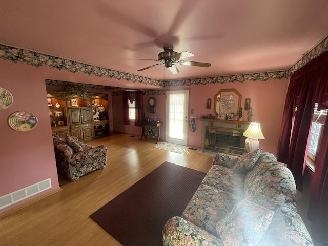 living room with ceiling fan and light hardwood / wood-style floors