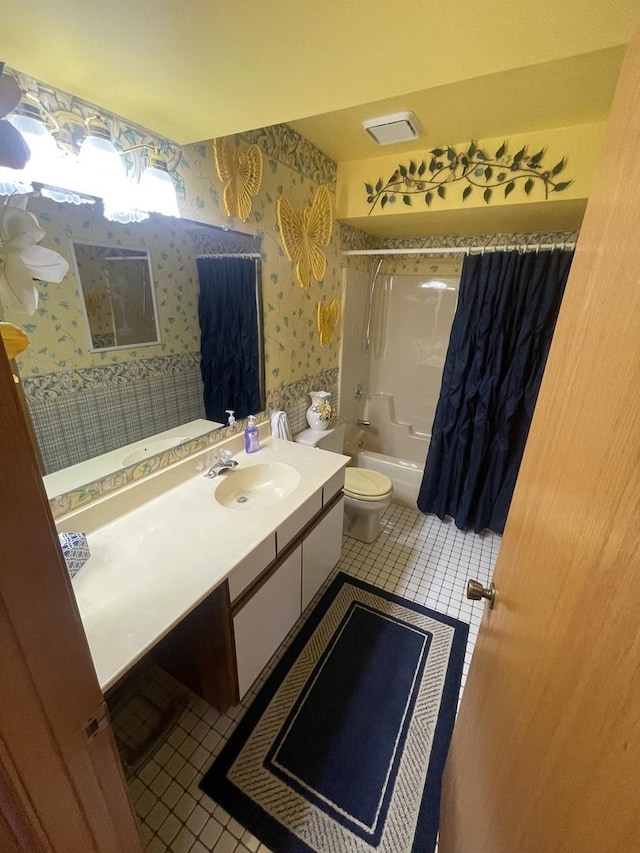 full bathroom featuring vanity, tile patterned floors, toilet, and shower / bath combo