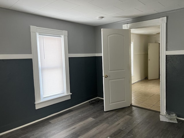 unfurnished room featuring dark hardwood / wood-style flooring