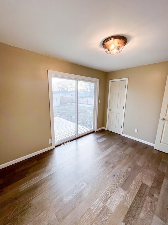 unfurnished room with hardwood / wood-style floors