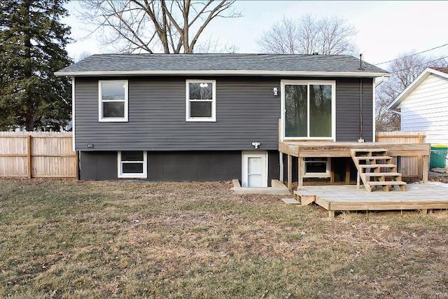 back of house with a yard and a deck