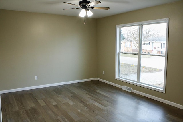 spare room featuring ceiling fan and dark hardwood / wood-style floors