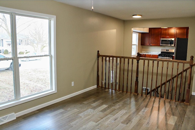 kitchen with wood-type flooring and appliances with stainless steel finishes