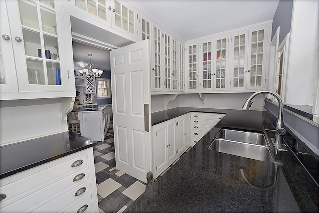 2221 Twin Oak Rd, Peru, IL 61354 - kitchen featuring a sink, white cabinets, a chandelier, and glass insert cabinets