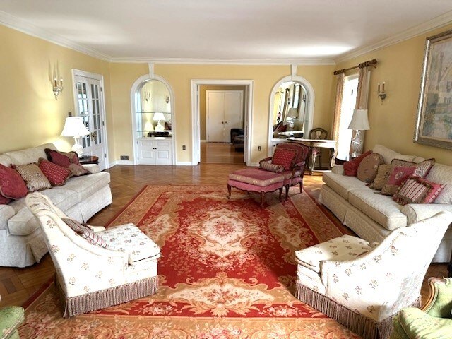 living area featuring crown molding