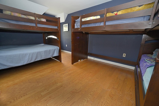 bedroom featuring baseboards and wood finished floors
