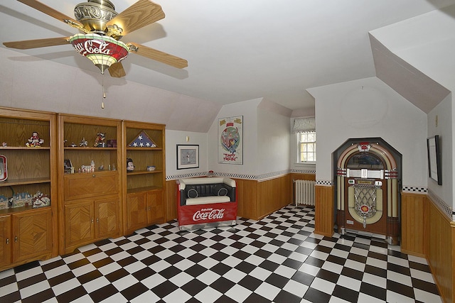 bonus room with tile patterned floors, a wainscoted wall, and a ceiling fan
