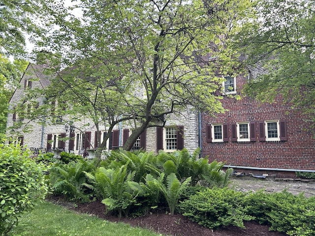 view of property exterior with brick siding