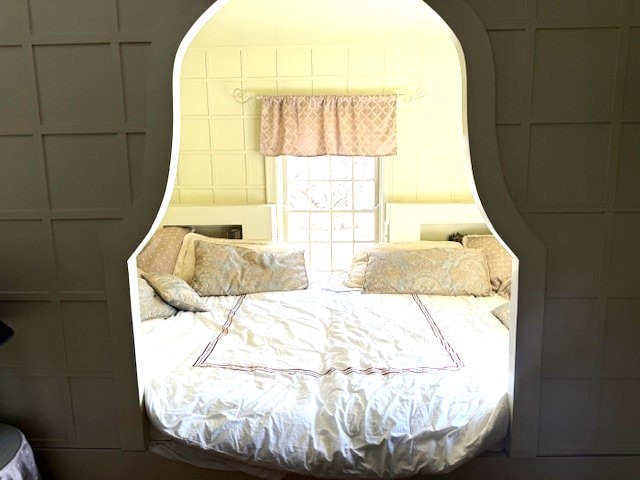bedroom featuring arched walkways