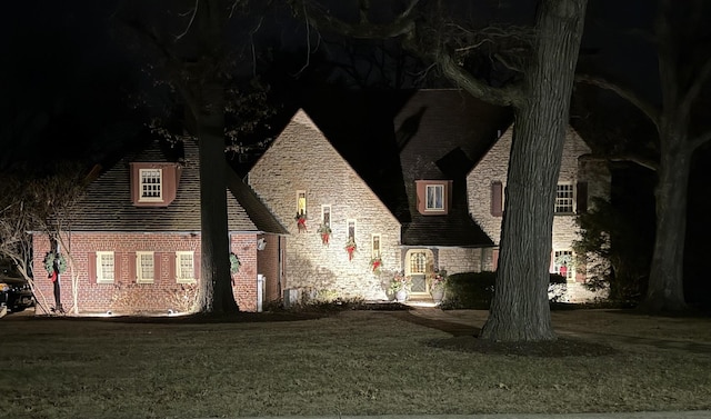 view of front of house featuring a front yard and stone siding