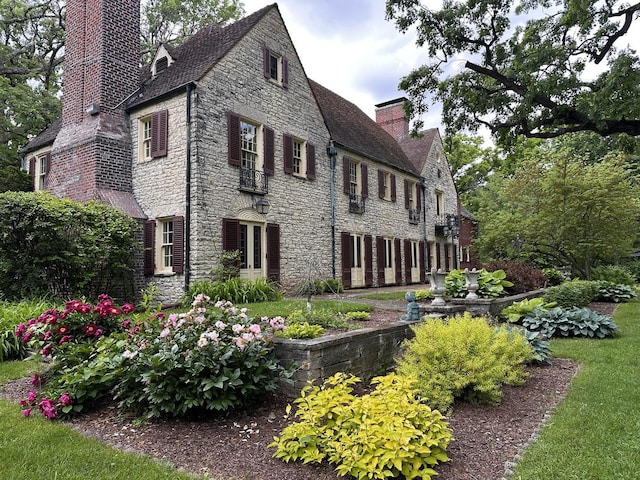 2221 Twin Oak Rd, Peru, IL 61354 - view of home's exterior with a chimney and stone siding