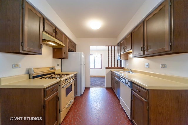 kitchen featuring sink and white appliances