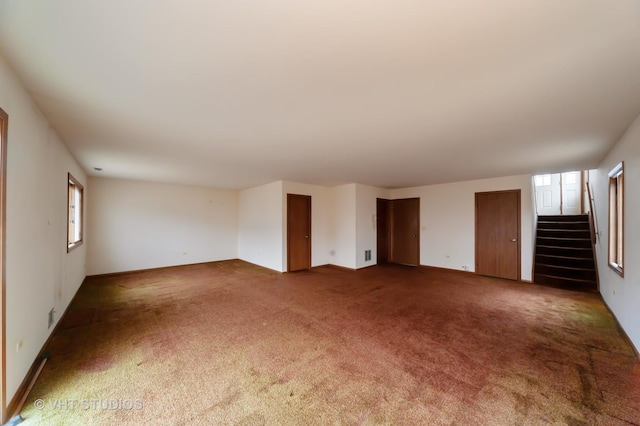 unfurnished living room featuring carpet flooring