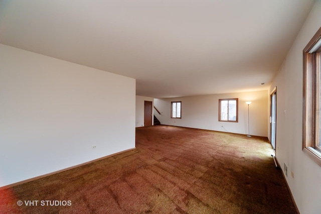 unfurnished room featuring carpet