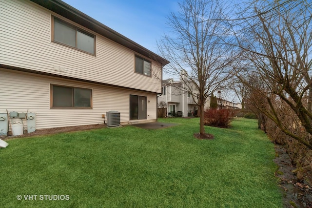 rear view of house with a yard, central AC, and a patio