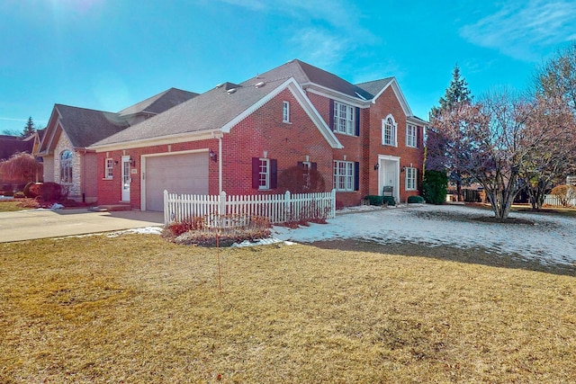 view of front of home with a garage and a front lawn