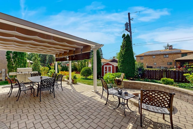 view of patio / terrace featuring area for grilling and a storage shed