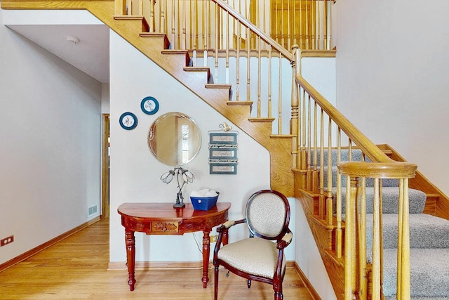 stairs with hardwood / wood-style floors