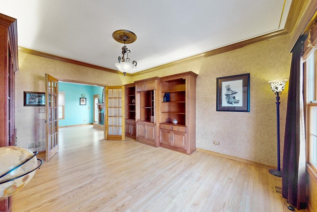 unfurnished living room featuring french doors, ornamental molding, and light hardwood / wood-style flooring