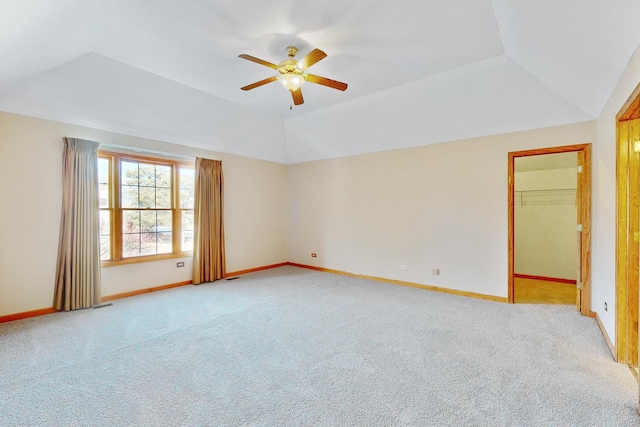 carpeted spare room with lofted ceiling and ceiling fan