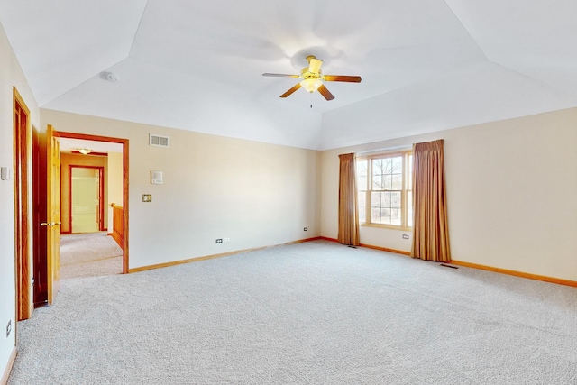 carpeted empty room featuring vaulted ceiling and ceiling fan