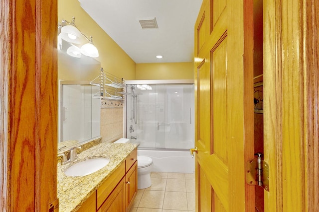 full bathroom featuring tile patterned flooring, vanity, toilet, and combined bath / shower with glass door