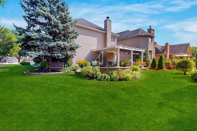 rear view of property with a yard and a pergola