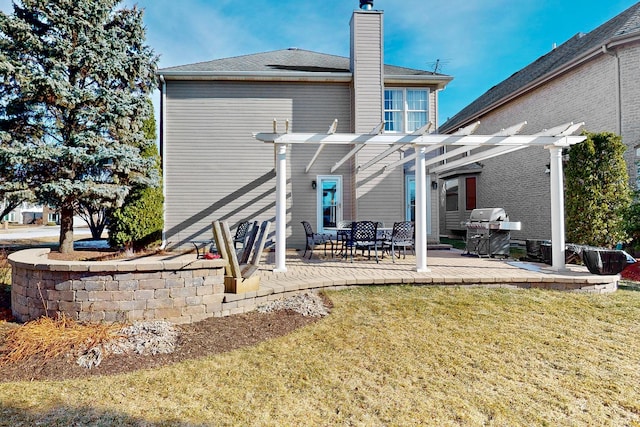 rear view of property featuring a yard, a pergola, and a patio area