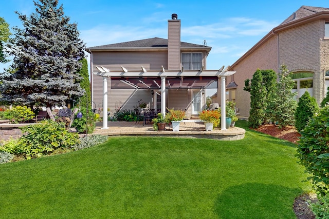 back of property with a patio, a lawn, and a pergola