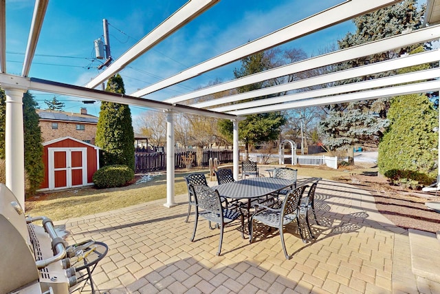 view of patio / terrace with a storage shed and a pergola