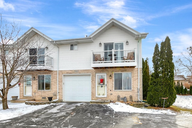 townhome / multi-family property featuring a garage and a balcony