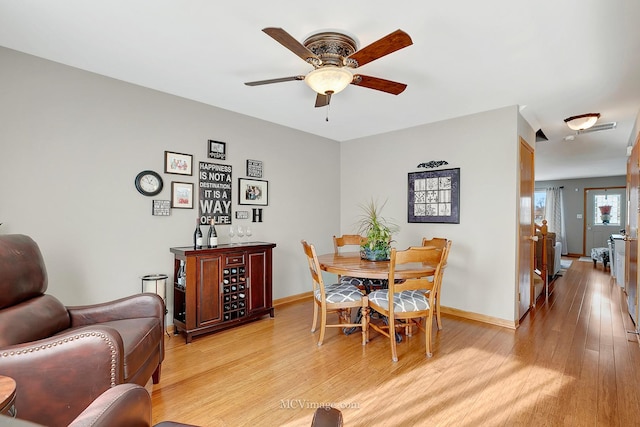 dining space with ceiling fan and light hardwood / wood-style floors