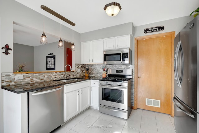 kitchen featuring tasteful backsplash, appliances with stainless steel finishes, sink, and white cabinets