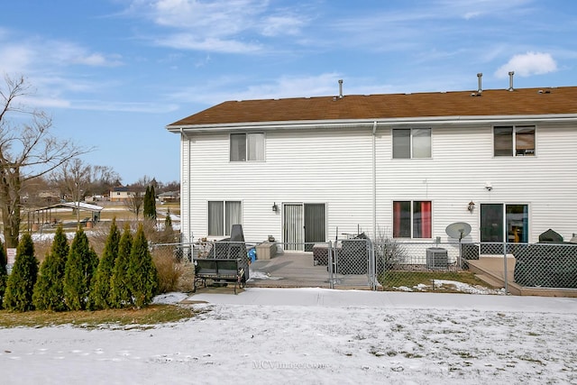 snow covered back of property featuring cooling unit