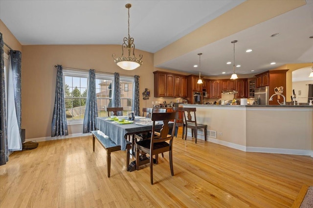 dining room featuring light wood-style flooring, recessed lighting, baseboards, lofted ceiling, and visible vents