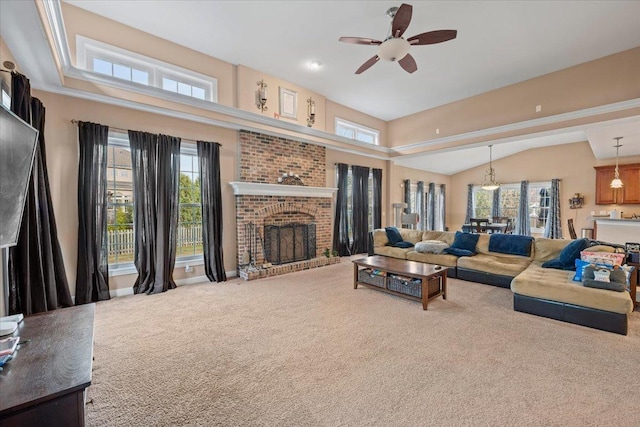 living area featuring carpet floors, a ceiling fan, and a fireplace