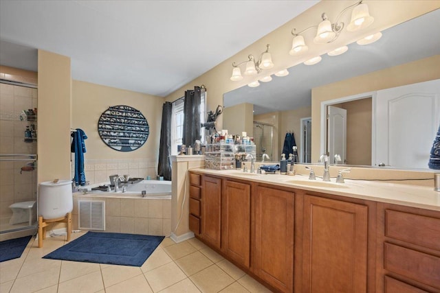 bathroom featuring double vanity, a garden tub, a stall shower, a sink, and tile patterned floors