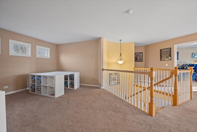 corridor with baseboards, carpet, and an upstairs landing