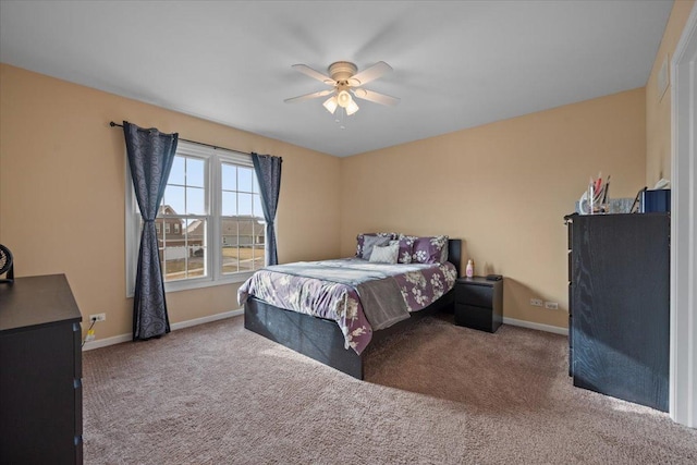 carpeted bedroom featuring a ceiling fan and baseboards