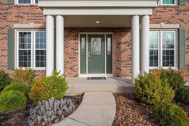property entrance featuring brick siding