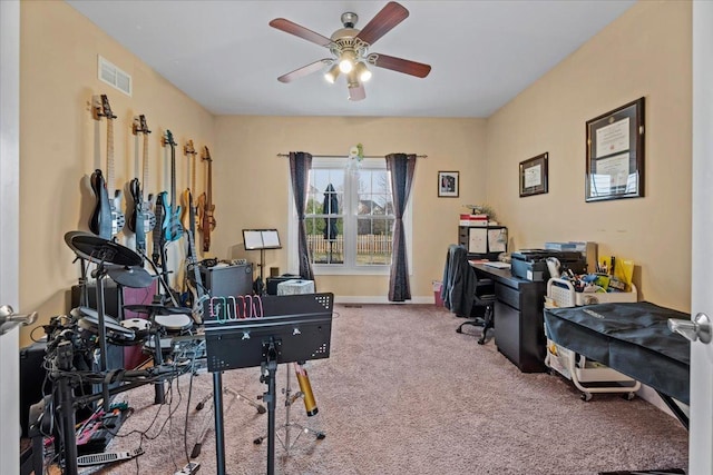 office area with carpet flooring, a ceiling fan, baseboards, and visible vents