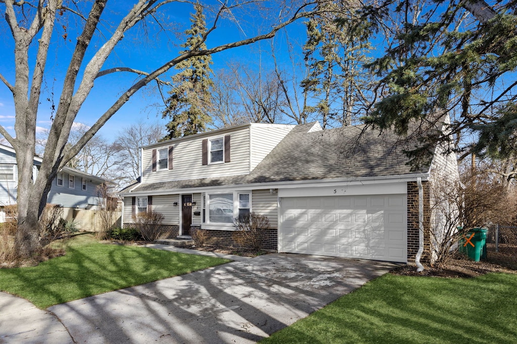 front of property with a garage and a front yard