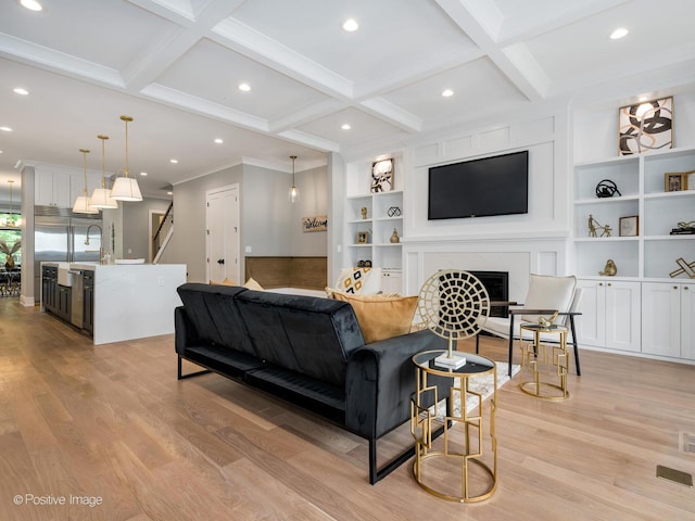 living room featuring coffered ceiling, beam ceiling, built in features, and light wood-type flooring