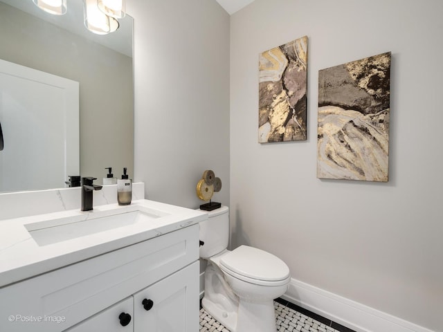 bathroom with tile patterned floors, vanity, and toilet