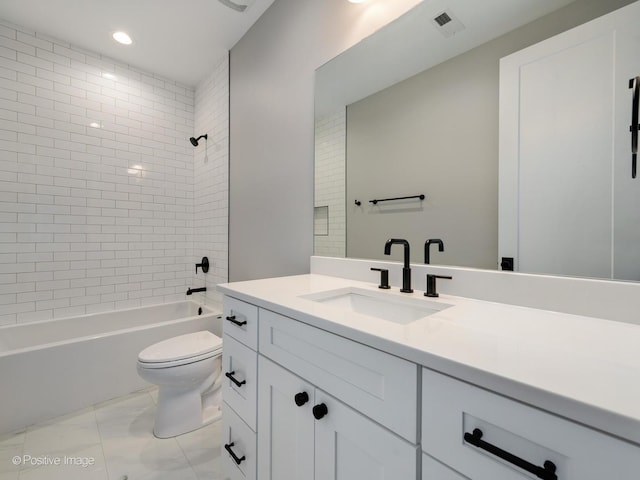 full bathroom featuring vanity, toilet, and tiled shower / bath