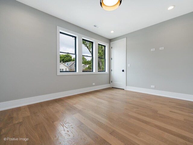 empty room with light hardwood / wood-style flooring