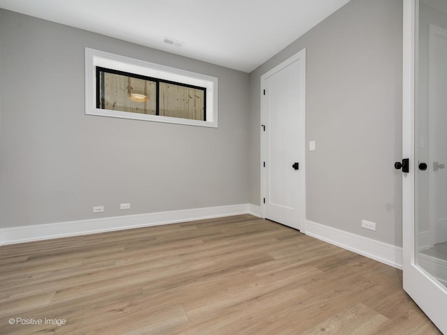 spare room featuring light hardwood / wood-style flooring